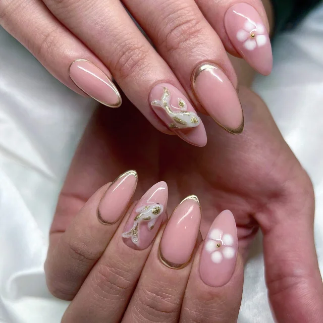 Elegant pink nails with floral designs.